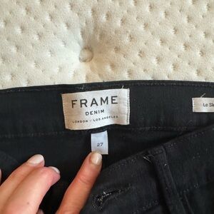 Size 27 Frame skinny jeans. Black. With flared raw edge bottom. 3/4 length.